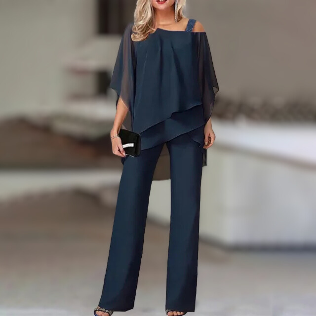 Experience refined style with this elegant chiffon ensemble featuring an asymmetric top paired with flowing wide-leg pants.