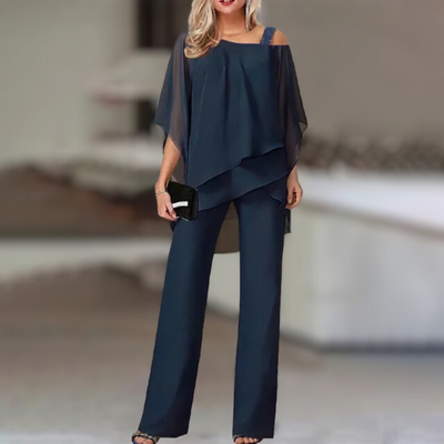 Experience refined style with this elegant chiffon ensemble featuring an asymmetric top paired with flowing wide-leg pants.