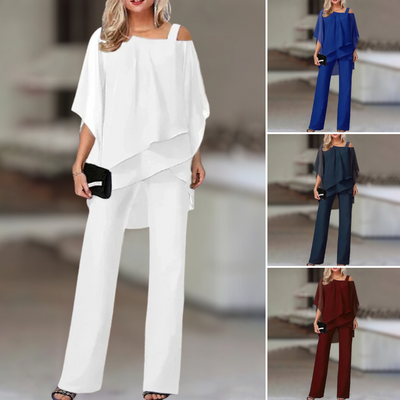 Experience refined style with this elegant chiffon ensemble featuring an asymmetric top paired with flowing wide-leg pants.