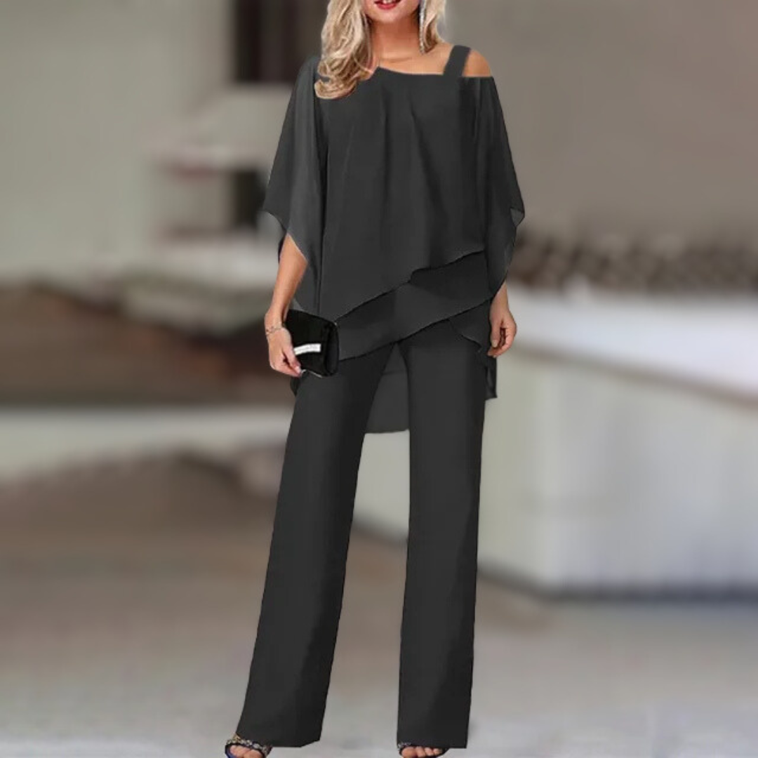Experience refined style with this elegant chiffon ensemble featuring an asymmetric top paired with flowing wide-leg pants.