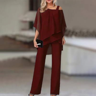 Experience refined style with this elegant chiffon ensemble featuring an asymmetric top paired with flowing wide-leg pants.