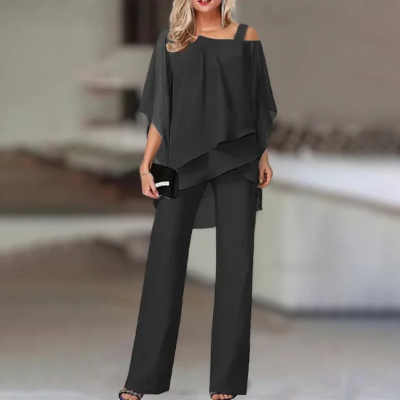 Experience refined style with this elegant chiffon ensemble featuring an asymmetric top paired with flowing wide-leg pants.